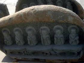 Buddha Carving in River Boulder